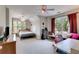 Spacious bedroom with lots of natural light, featuring a ceiling fan and comfortable seating at 36 Evergreen Way, Dallas, GA 30157