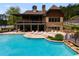 Stunning community pool with sundeck, stone accents, and nearby clubhouse at 36 Evergreen Way, Dallas, GA 30157