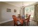 Dining room with a wood table, wood chairs, chandelier, and a backyard view at 36 Evergreen Way, Dallas, GA 30157