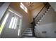 Bright entryway featuring a staircase with black wrought iron railing and a chandelier at 36 Evergreen Way, Dallas, GA 30157