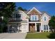 Charming two-story home featuring a stone facade, blue shutters, manicured lawn, and a two-car garage at 36 Evergreen Way, Dallas, GA 30157