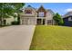 Charming two-story home featuring a two-car garage, stone accents, red shutters, and a well-manicured lawn at 36 Evergreen Way, Dallas, GA 30157