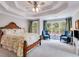 Spacious main bedroom boasts a trey ceiling, carpet floors, and a lovely seating area at 36 Evergreen Way, Dallas, GA 30157