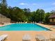 A spacious community pool and lounge area provides a relaxing space with lounge chairs and manicured landscaping at 36 Evergreen Way, Dallas, GA 30157