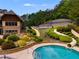 An inviting pool area with water slides and lush landscaping offers a refreshing escape and recreational opportunities at 36 Evergreen Way, Dallas, GA 30157