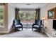 Sitting area with large windows and two blue cushioned chairs in the main bedroom at 36 Evergreen Way, Dallas, GA 30157