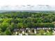Aerial view of house surrounded by wooded neighborhood and close to city amenities at 6859 Winding Wade Trl, Austell, GA 30168