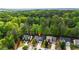 Aerial view of house surrounded by wooded neighborhood and close to city amenities at 6859 Winding Wade Trl, Austell, GA 30168