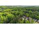 Aerial view of house surrounded by wooded neighborhood and close to city amenities at 6859 Winding Wade Trl, Austell, GA 30168