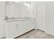 Modern bathroom with double sinks, white cabinets, and gray tiled floor at 6859 Winding Wade Trl, Austell, GA 30168