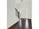 Bright entryway with hardwood floors, a staircase, a pendant light, and a white front door at 6859 Winding Wade Trl, Austell, GA 30168