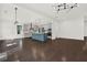 Open floor plan with a blue kitchen island, stainless steel appliances, and dark hardwood floors at 6859 Winding Wade Trl, Austell, GA 30168