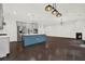 Open-concept kitchen and living area with stainless steel appliances and dark hardwood floors at 6859 Winding Wade Trl, Austell, GA 30168