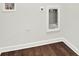 Laundry room featuring a stainless steel utility sink, dark hardwood floors, and white walls at 6859 Winding Wade Trl, Austell, GA 30168