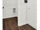 Laundry room featuring a stainless steel utility sink, dark hardwood floors, and white walls at 6859 Winding Wade Trl, Austell, GA 30168
