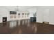 Bright living room with dark hardwood floors, fireplace, and view of kitchen and backyard at 6859 Winding Wade Trl, Austell, GA 30168