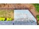 Aerial view of backyard patio with lawn, landscaping, and wooden retaining wall at 6859 Winding Wade Trl, Austell, GA 30168