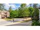 Street view of brick home in wooded neighborhood with view of landscaped yards and sidewalks at 6859 Winding Wade Trl, Austell, GA 30168