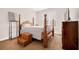 Traditional bedroom with four-poster bed and dark wood furniture set at 1129 Abundance Dr, Locust Grove, GA 30248
