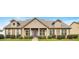 Inviting single-story home featuring a symmetrical facade, manicured lawn, and a charming blue front door at 1129 Abundance Dr, Locust Grove, GA 30248