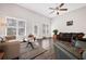Bright living room with vaulted ceilings, large windows, and hardwood floors featuring a cozy seating area at 1129 Abundance Dr, Locust Grove, GA 30248