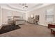 Spacious main bedroom features a tray ceiling, plush carpet, and abundant natural light at 1129 Abundance Dr, Locust Grove, GA 30248