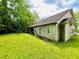 Exterior back of home featuring large yard and mature trees at 1528 Buckingham Pl, Stockbridge, GA 30281