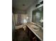 View of a bathroom with a tub and sink in need of repair at 1528 Buckingham Pl, Stockbridge, GA 30281