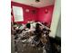 Bright bedroom in need of cleaning with a window and clutter on the floor at 1528 Buckingham Pl, Stockbridge, GA 30281