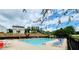 Community pool with chairs and umbrellas set on a sunny day at 1528 Buckingham Pl, Stockbridge, GA 30281