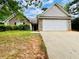 Charming one story home featuring stone accents, two-car garage, and a traditional, well-maintained lawn at 1528 Buckingham Pl, Stockbridge, GA 30281