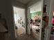 Hallway that leads to the living spaces needing repair with peeling paint, damage and debris at 1528 Buckingham Pl, Stockbridge, GA 30281