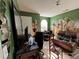 Living area needing some TLC with natural light, green walls and furniture at 1528 Buckingham Pl, Stockbridge, GA 30281