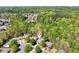 An aerial shot of a home nestled among lush trees in a residential community at 1670 Bookhout Dr, Cumming, GA 30041
