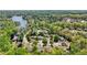 An aerial view showcasing a community of houses nestled near a tranquil lake at 1670 Bookhout Dr, Cumming, GA 30041