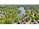 An aerial view of homes situated in a community next to a pond at 1670 Bookhout Dr, Cumming, GA 30041