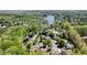 Aerial view of a residential neighborhood with mature trees and a scenic lake at 1670 Bookhout Dr, Cumming, GA 30041