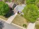 Aerial view of a home with green lawn, and trees, situated in a neighborhood with sidewalks at 1670 Bookhout Dr, Cumming, GA 30041