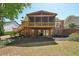 Brick home featuring an elevated screened porch, wood deck, patio and outdoor seating area at 1670 Bookhout Dr, Cumming, GA 30041
