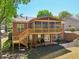 Charming backyard featuring a spacious screened porch, a wooden deck with steps, and a serene mulch area at 1670 Bookhout Dr, Cumming, GA 30041