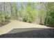 Large backyard featuring lush greenery, manicured landscaping, and a serene setting at 1670 Bookhout Dr, Cumming, GA 30041