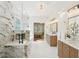 Lavish bathroom with a marble shower, tub, double sinks, and wood cabinets at 1670 Bookhout Dr, Cumming, GA 30041