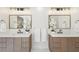 Bright bathroom featuring double sinks with quartz countertops and modern fixtures at 1670 Bookhout Dr, Cumming, GA 30041