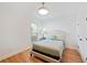 Bedroom with wood floor, upholstered headboard, and natural light at 1670 Bookhout Dr, Cumming, GA 30041