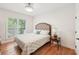 Bedroom with wood floor, upholstered headboard, and window at 1670 Bookhout Dr, Cumming, GA 30041