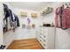 Walk-in closet with hardwood floor, wire shelving, clothes and basket storage at 1670 Bookhout Dr, Cumming, GA 30041