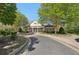 Elegant community clubhouse featuring a covered entrance, decorative columns, and beautifully maintained landscaping at 1670 Bookhout Dr, Cumming, GA 30041