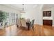 Elegant dining room with hardwood floors, plantation shutters, and decorative lighting at 1670 Bookhout Dr, Cumming, GA 30041