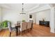 An inviting dining room with hardwood floors and decorative wall trim at 1670 Bookhout Dr, Cumming, GA 30041