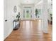 Welcoming foyer featuring hardwood floors, a decorative table, and view to the front door at 1670 Bookhout Dr, Cumming, GA 30041